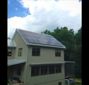 Solar panels on roof of house by trees