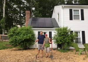 Homeowners with solar panels on roof
