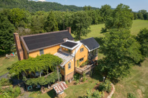 2 story yellow country home with rooftop solar