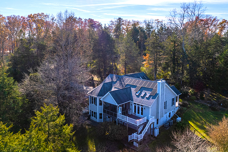 Home in forest with solar panels